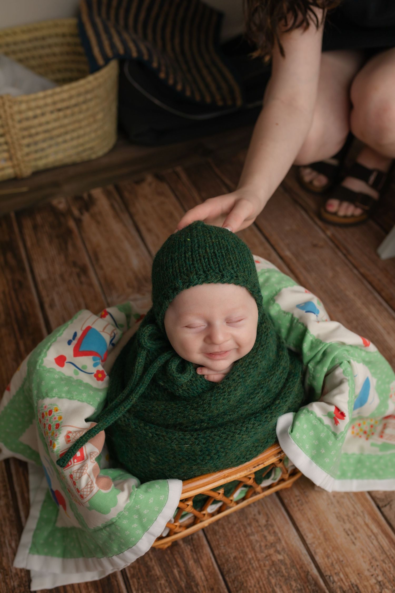 Harrisonburg Photographer, newborn, family, baby, unedited picture of baby boy in green with quilt, mom supporting head