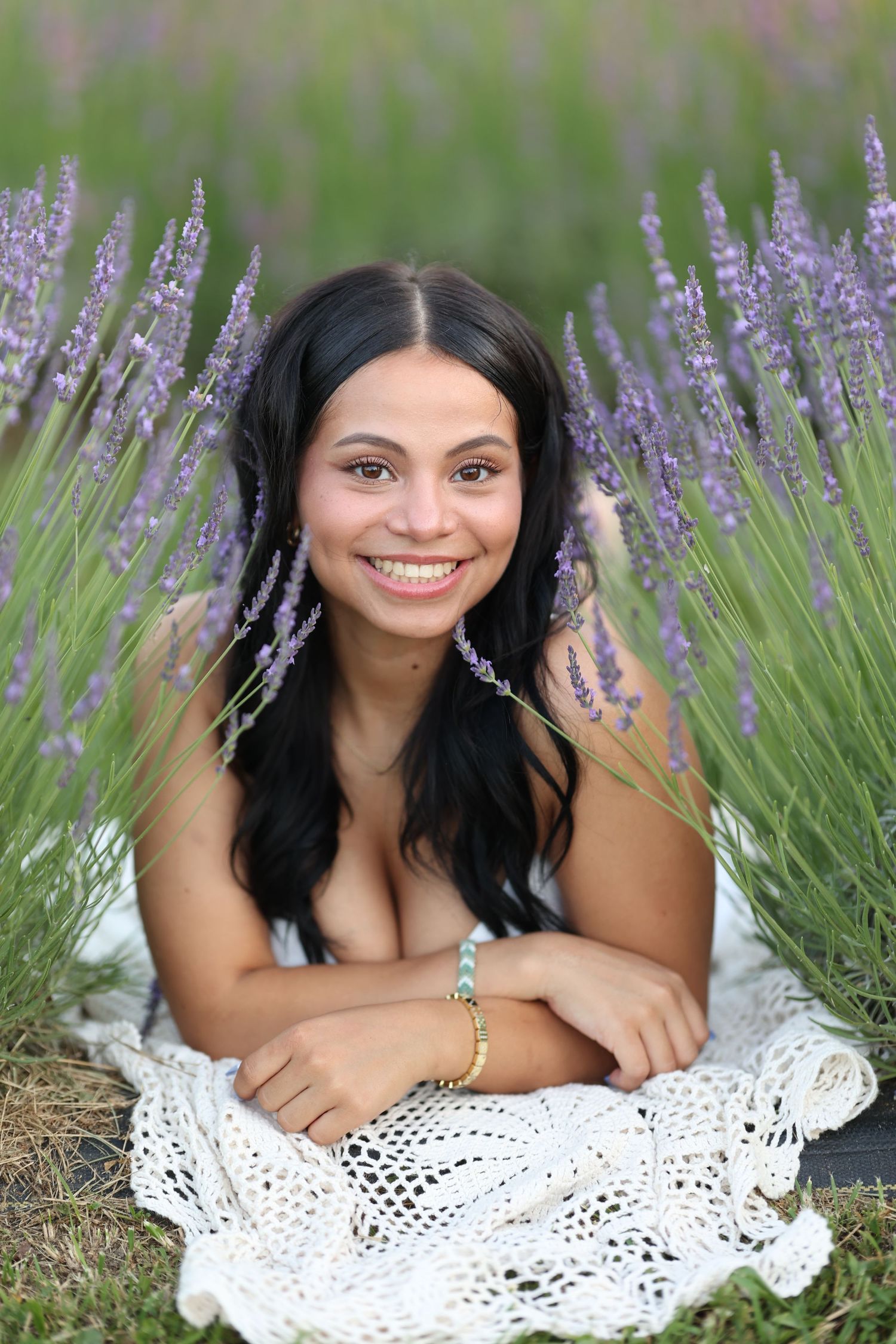 A series of portraits taken in a blooming lavender field with a white crocheted blanket as a prop. Middle Tennessee Best Senior Photographer
