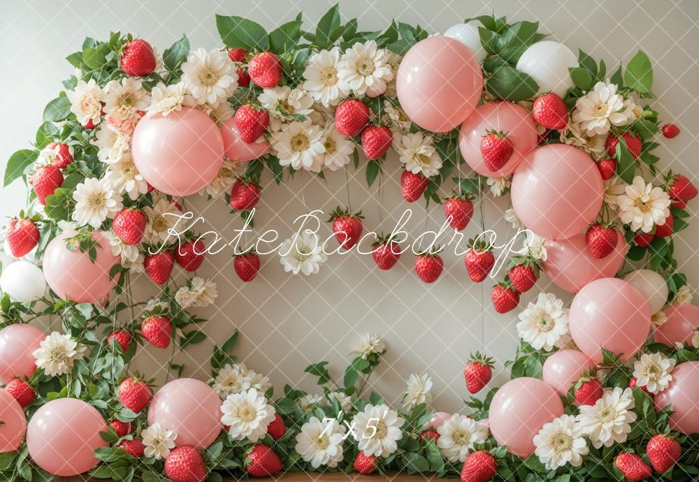 A decorative garland with pink paper lanterns, white daisies, and artificial strawberries against a light background.