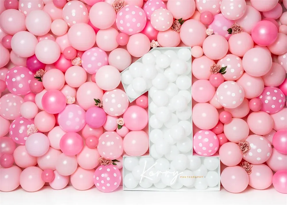 Pink balloon wall backdrop with white number one centerpiece for a first birthday party celebration.