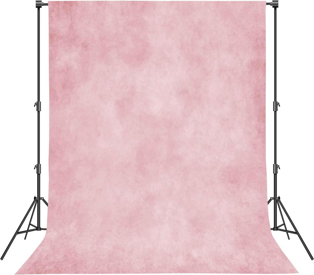 Pink mottled photography backdrop on adjustable stands, soft textured blush background for portrait studio photography.