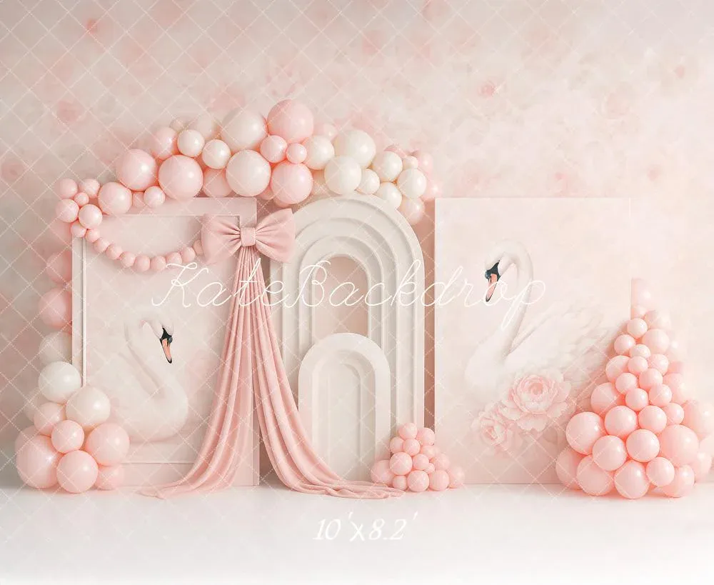 Elegant pink balloon arch with white door backdrop and flowing pink fabric drapes creating a romantic party setup.