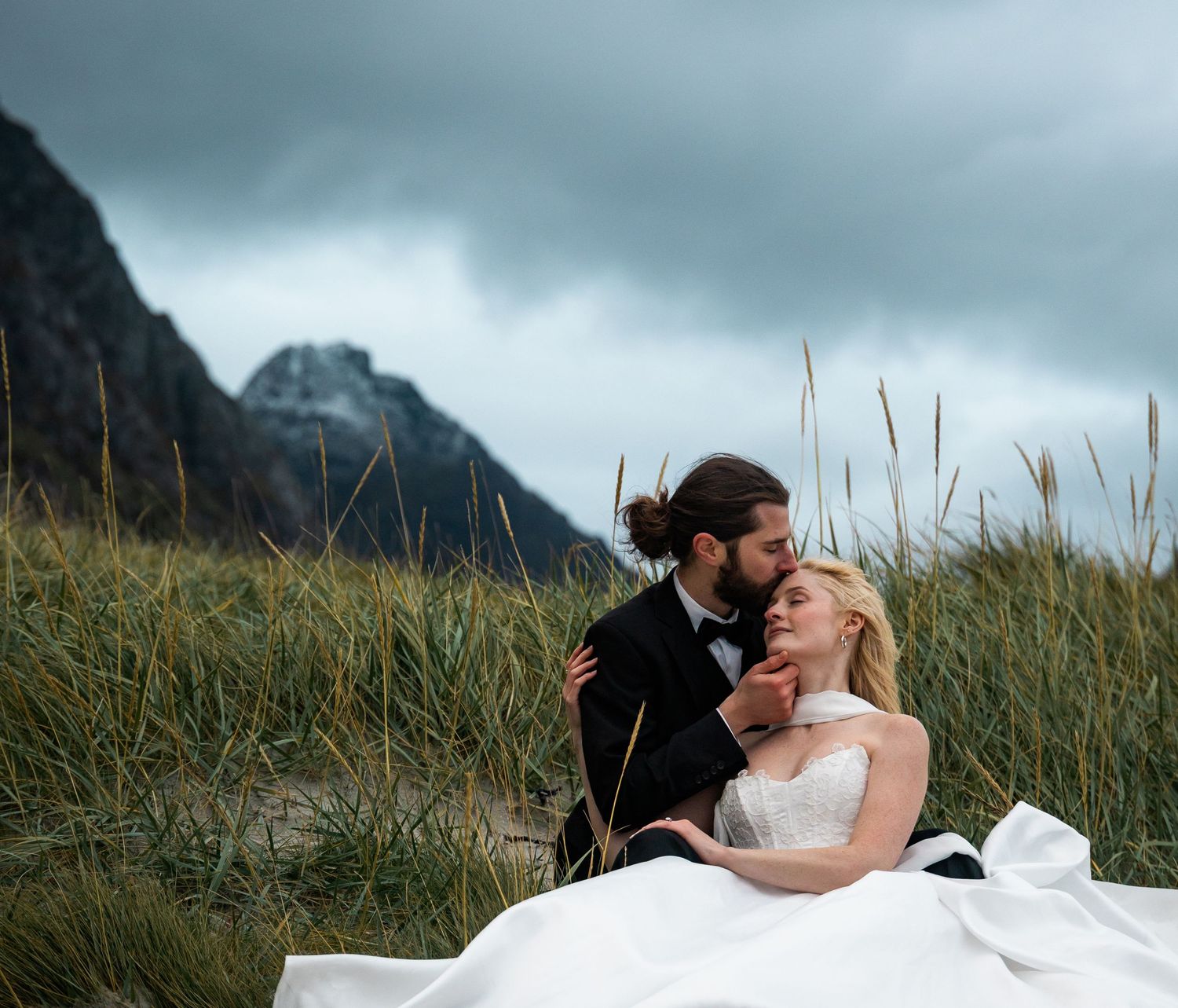 Black and white wedding portrait with scenic mountain backdrop.
