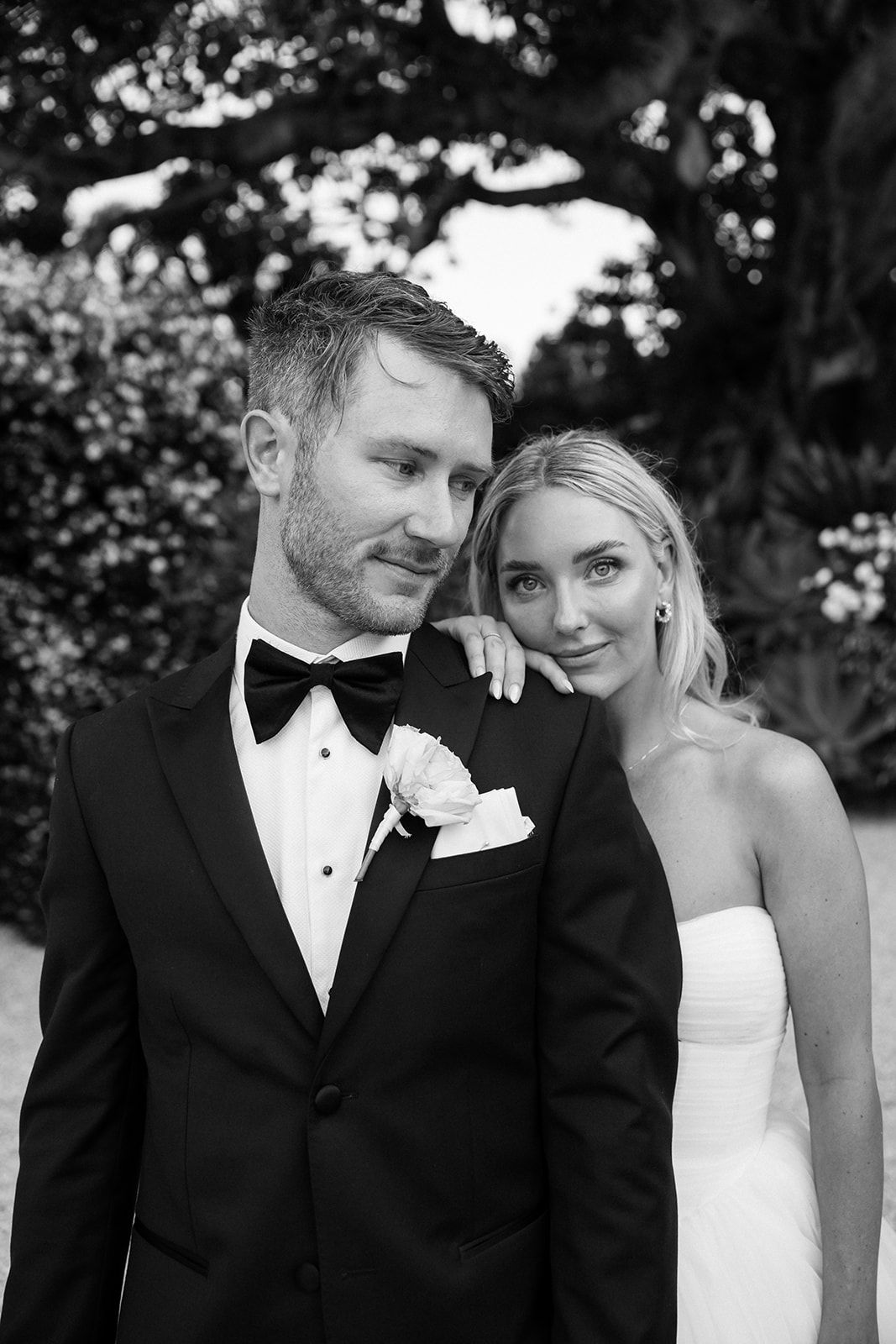 Romantic black and white portrait on balcony with architectural details.