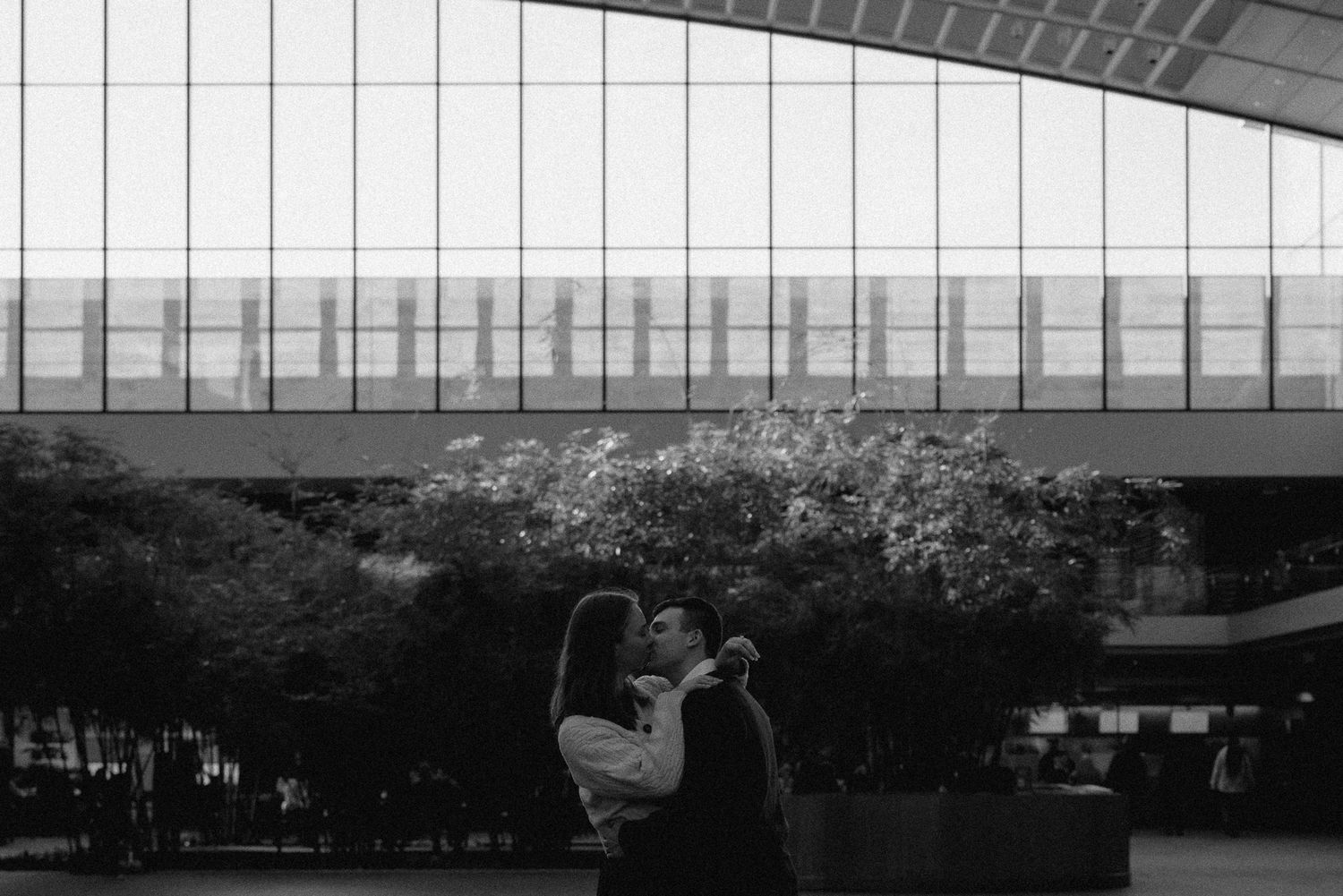 Engaged couple kissing out front of the Cleveland Museum of Art captured by Cleveland wedding photographer.