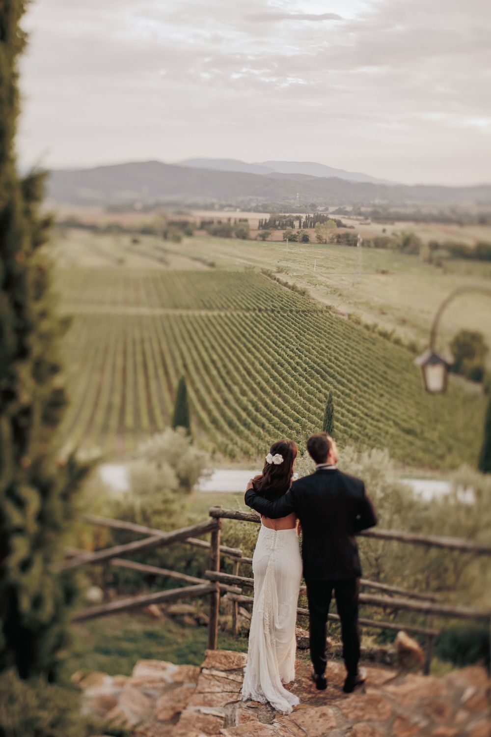 Couple admiring scenic vineyard views from a hilltop overlook.