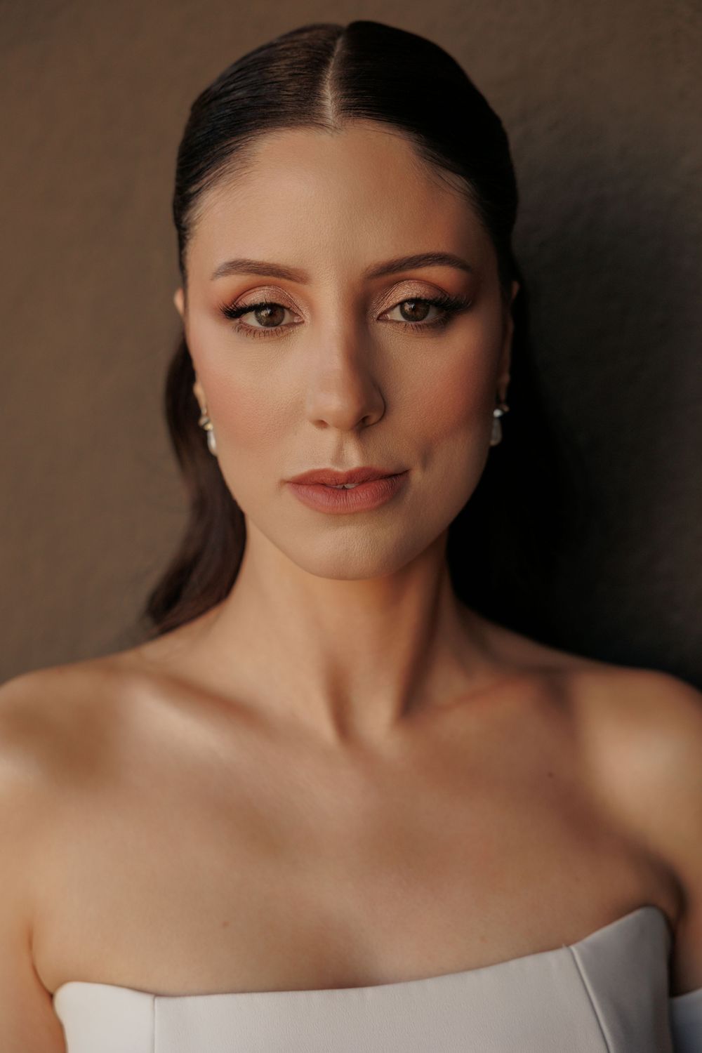 Dramatic portrait series showing cinematic close-ups with soft lighting and glamorous makeup against a dark background.