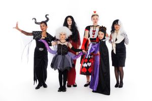 Group dressed in Halloween costumes posing together against white background.