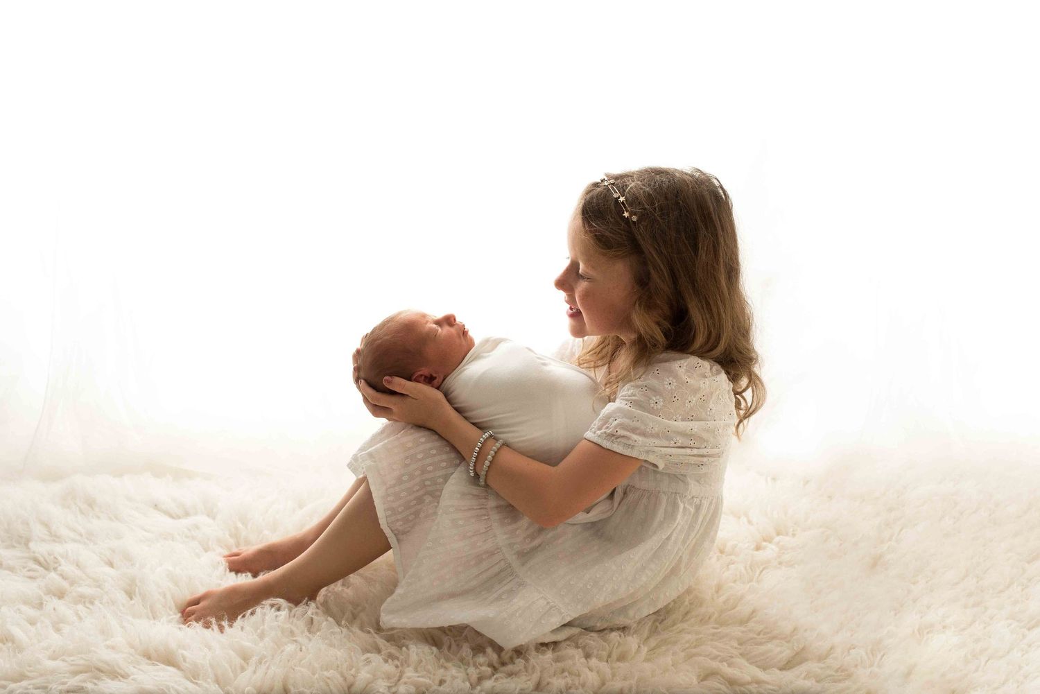 Artistic newborn portrait with a big sister, photographed by Woodbury newborn photographer