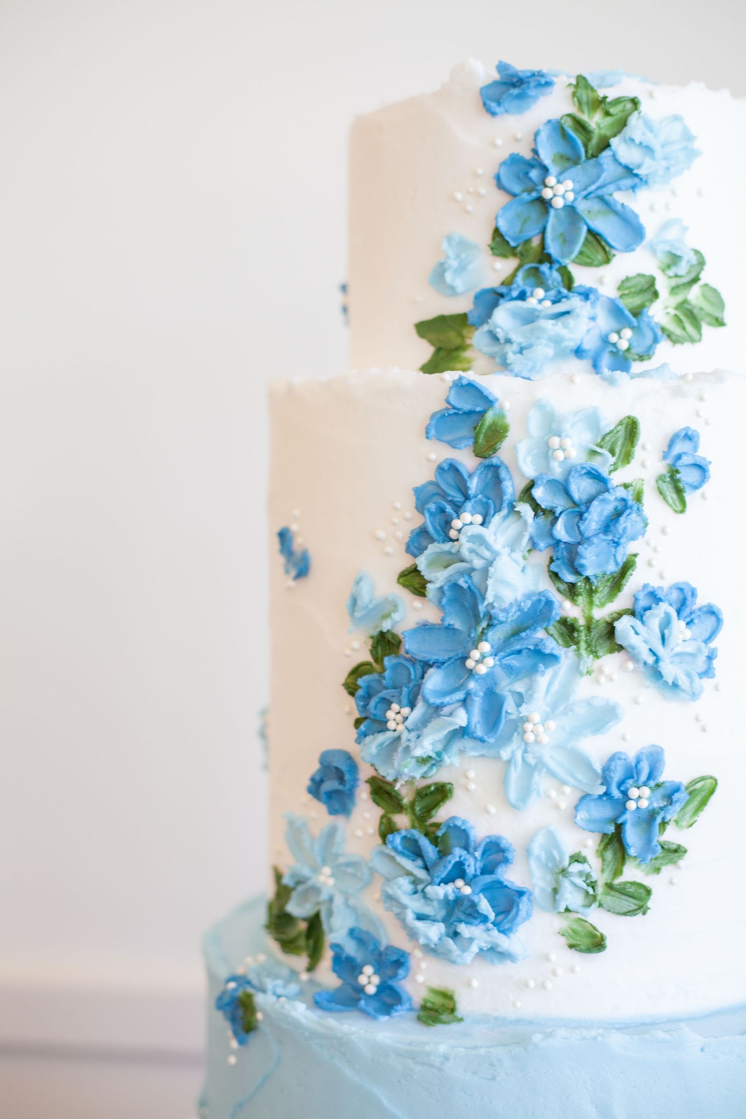 A white and blue floral 2 tier wedding cake