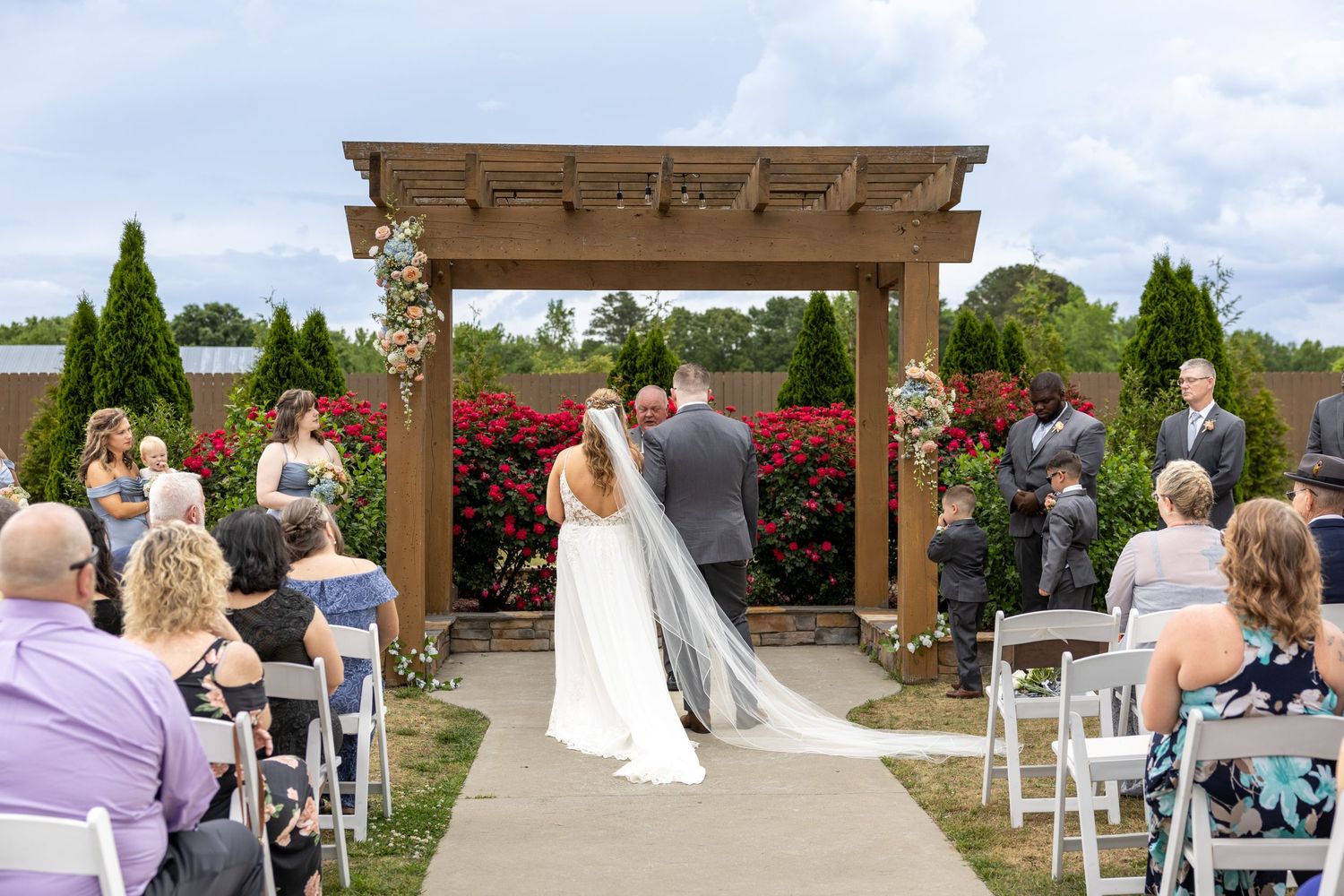 A couple stands at the alter at their Wilkin's Farm wedding in NC.