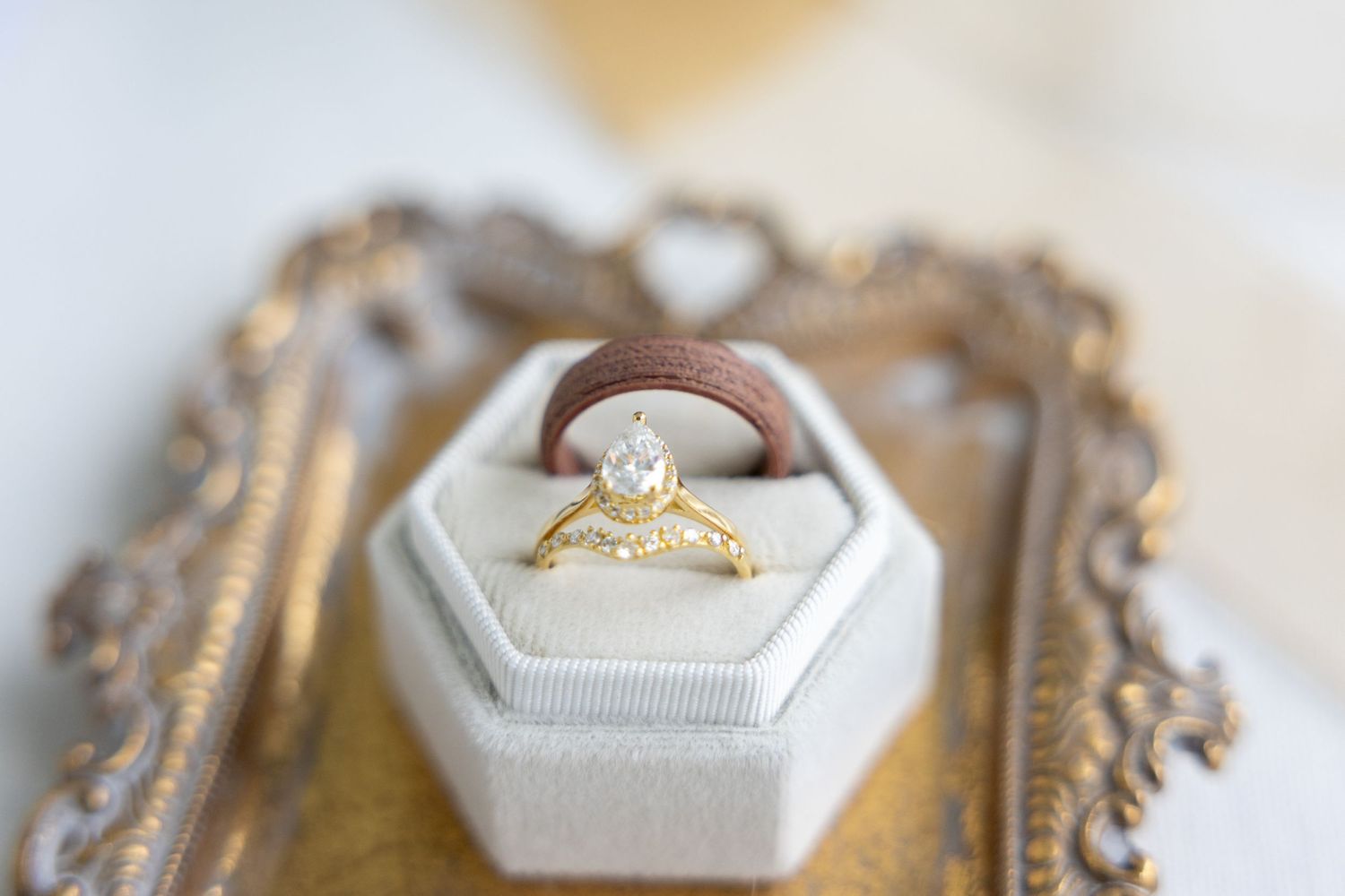 Raleigh NC wedding photographer detail photo featuring rings on a gold dish.