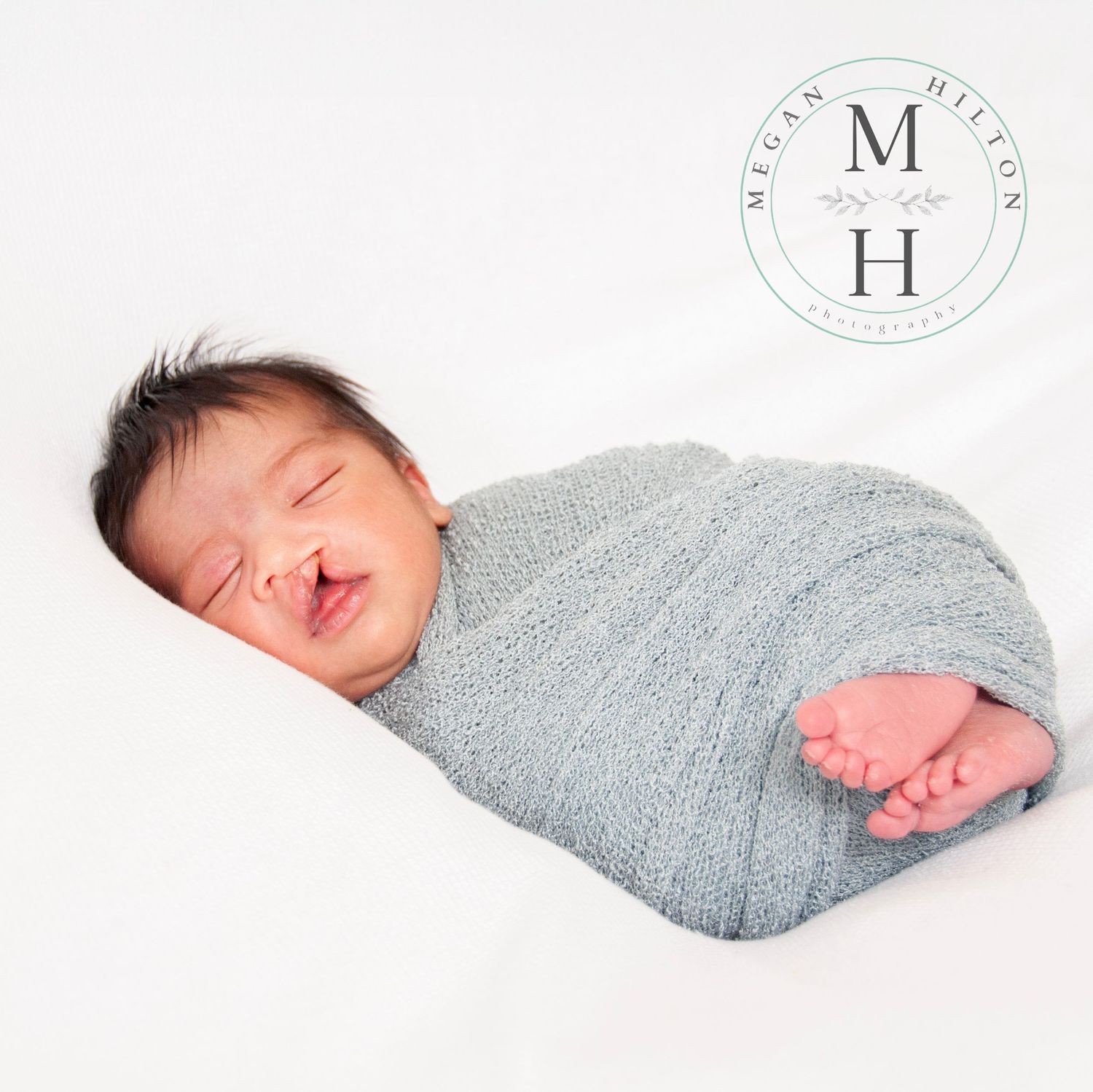 newborn boy wrapped with toes out image
