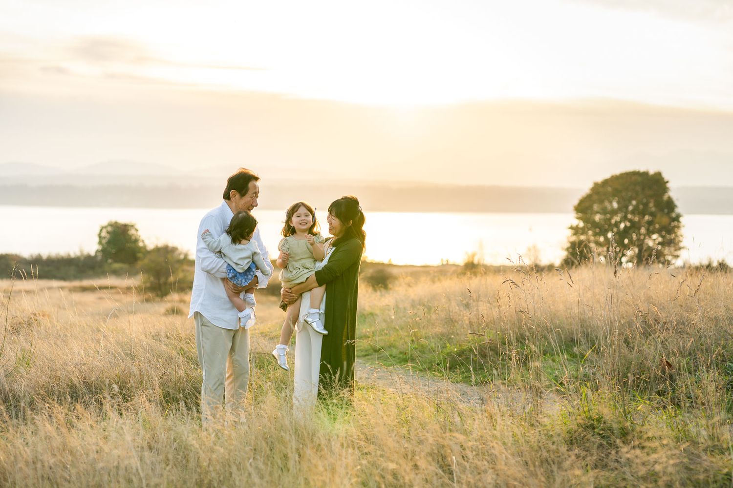 Candid photo of grandparents with grandchildren at the Discovery Park bluff in Seattle.