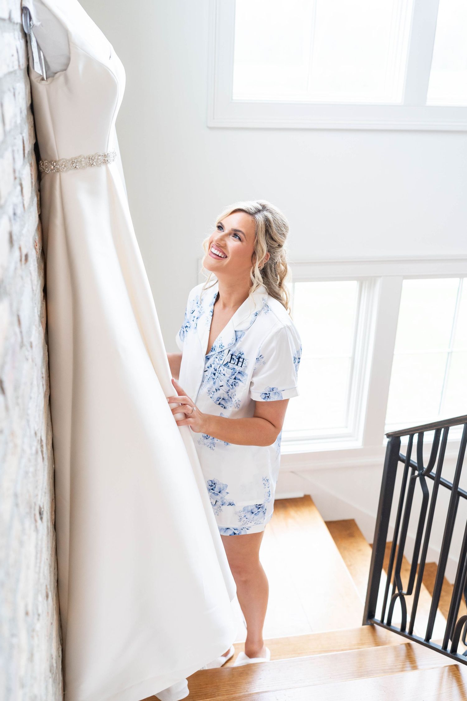 bride looks at wedding dress