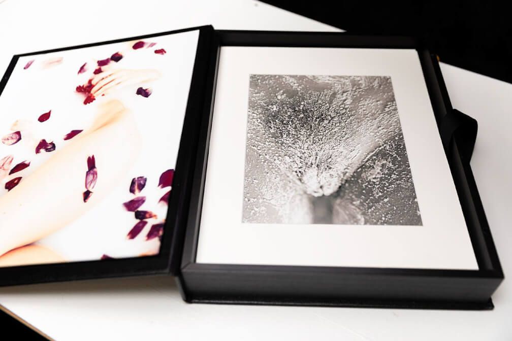 Black-framed photography prints showcasing artistic photographs with red accents and monochrome elements.