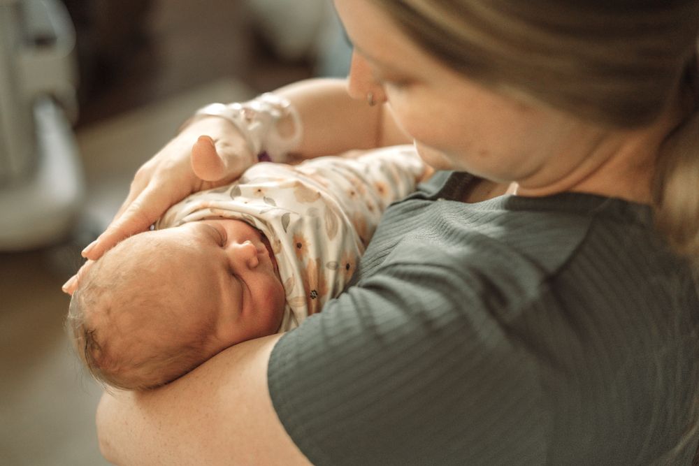 Mom tending to her new baby at the hospital