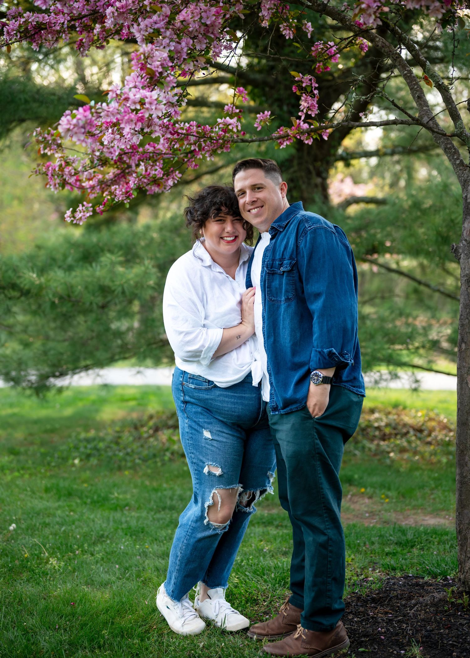 A couple embracing standing under a blossom tree. Wrightstown NJ Family Photographer