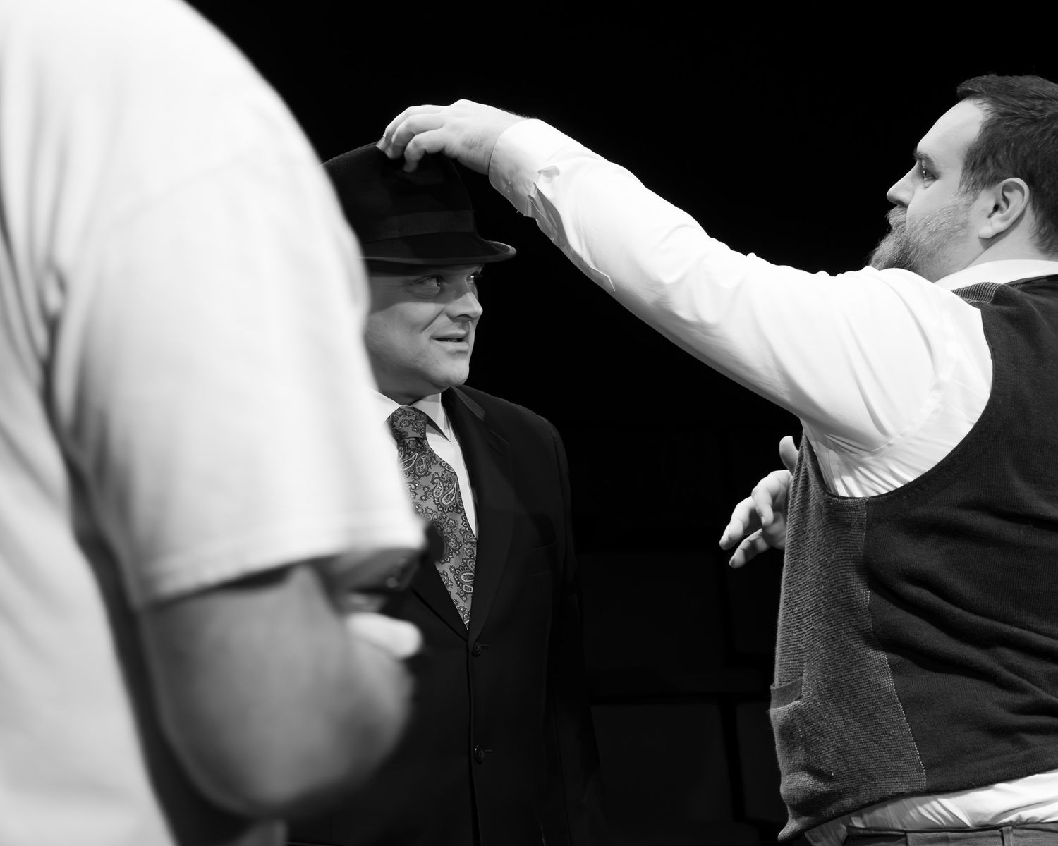 A series of black and white photos showing people backstage of a theatre