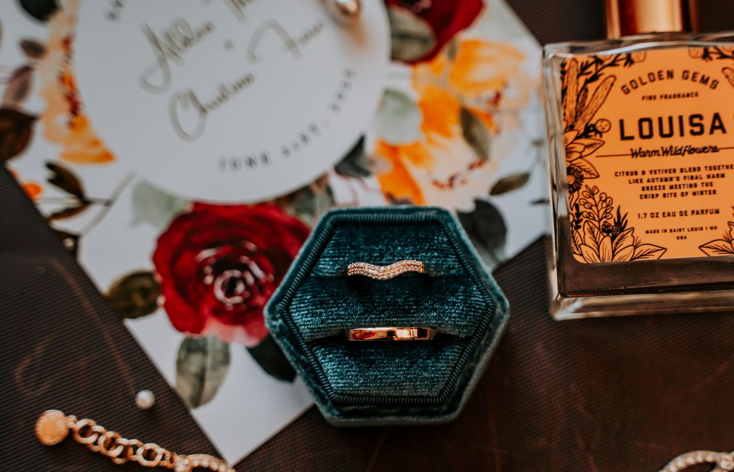 A close-up view of vintage perfume bottles and paper cards arranged on a dark wooden surface.