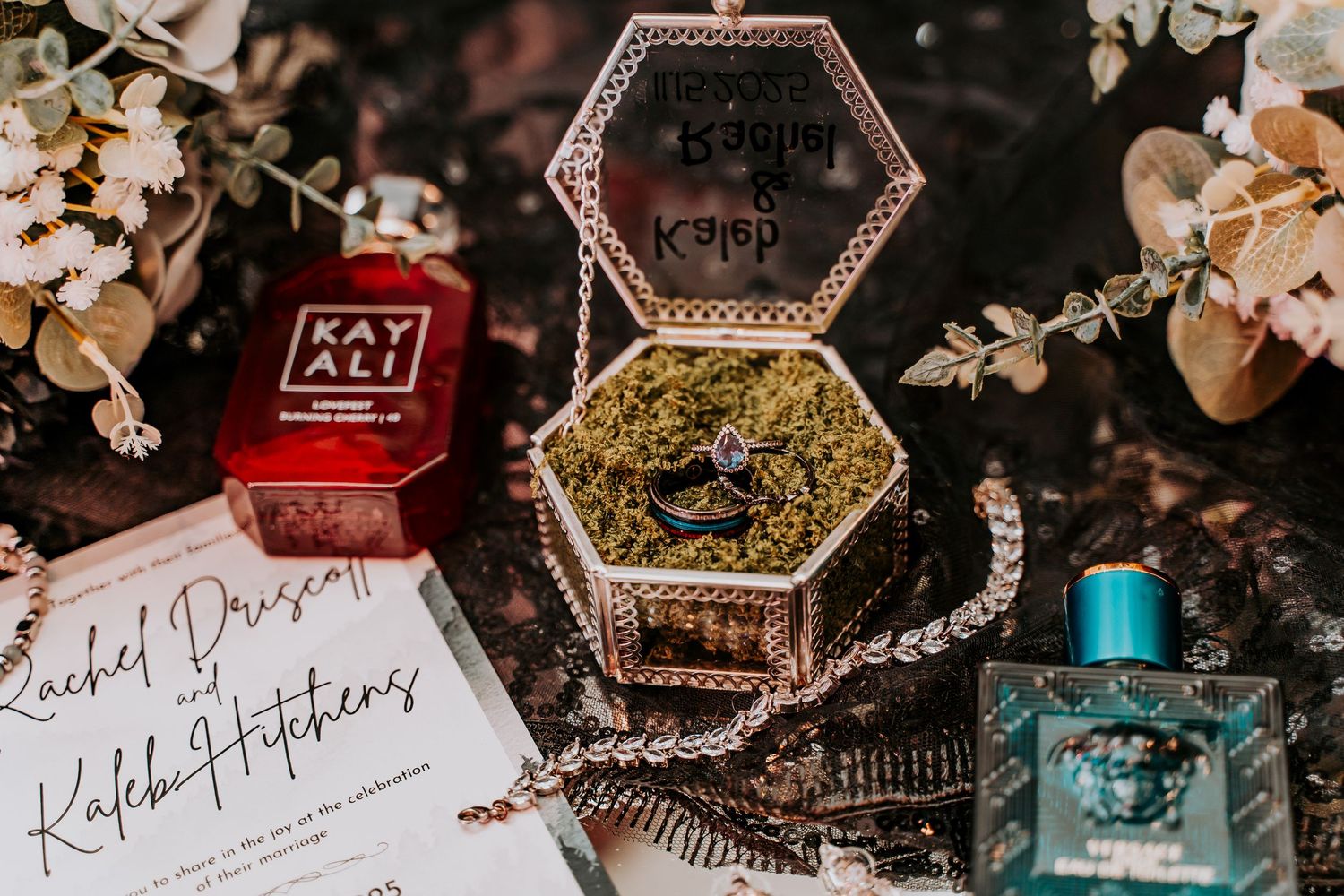 Vintage hexagonal jewelry box with perfume bottles and handwritten note on dark moody background.