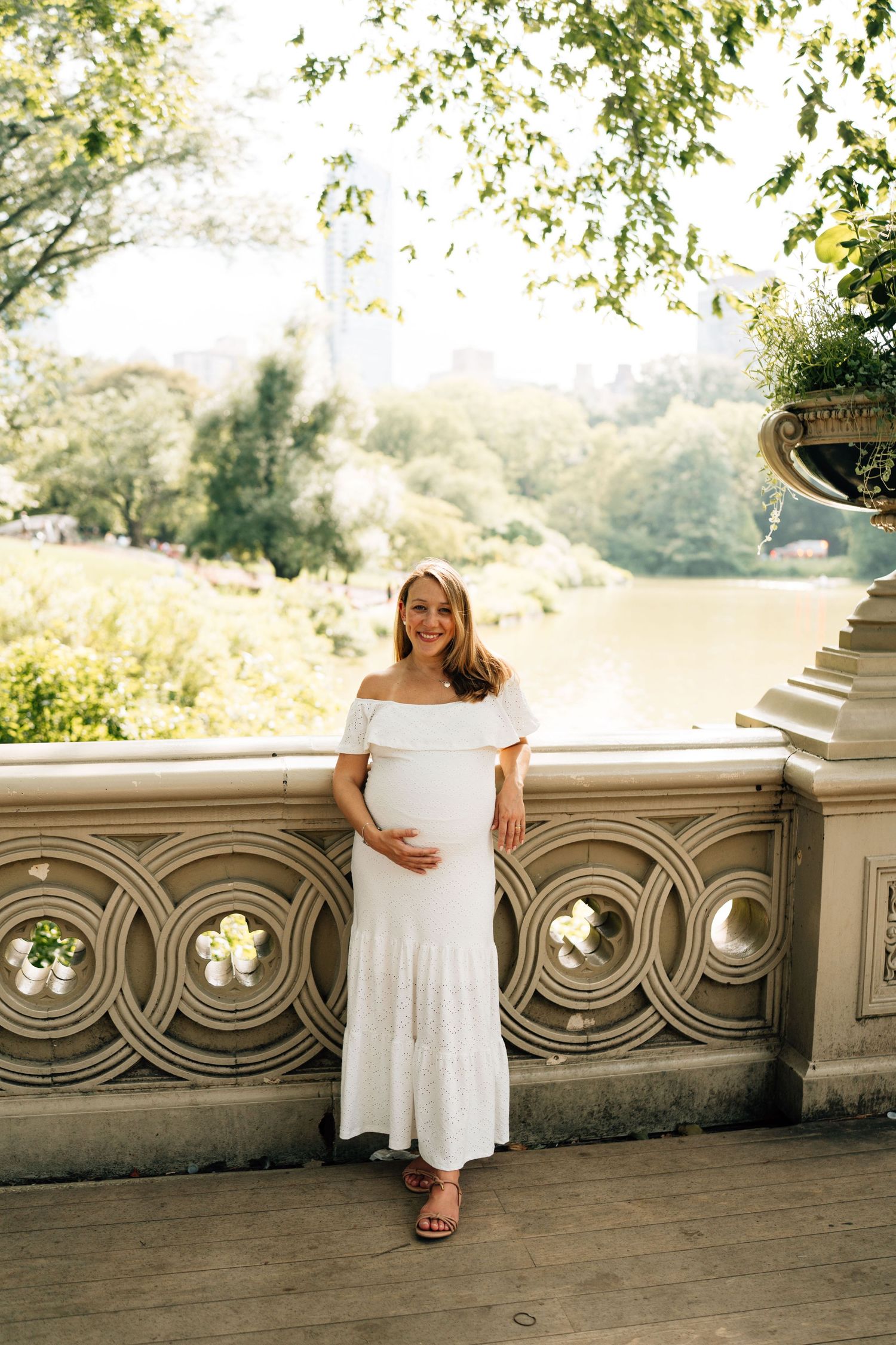 A series of photos shows someone in a white dress posing along an ornate stone balcony in a sunlit outdoor setting.