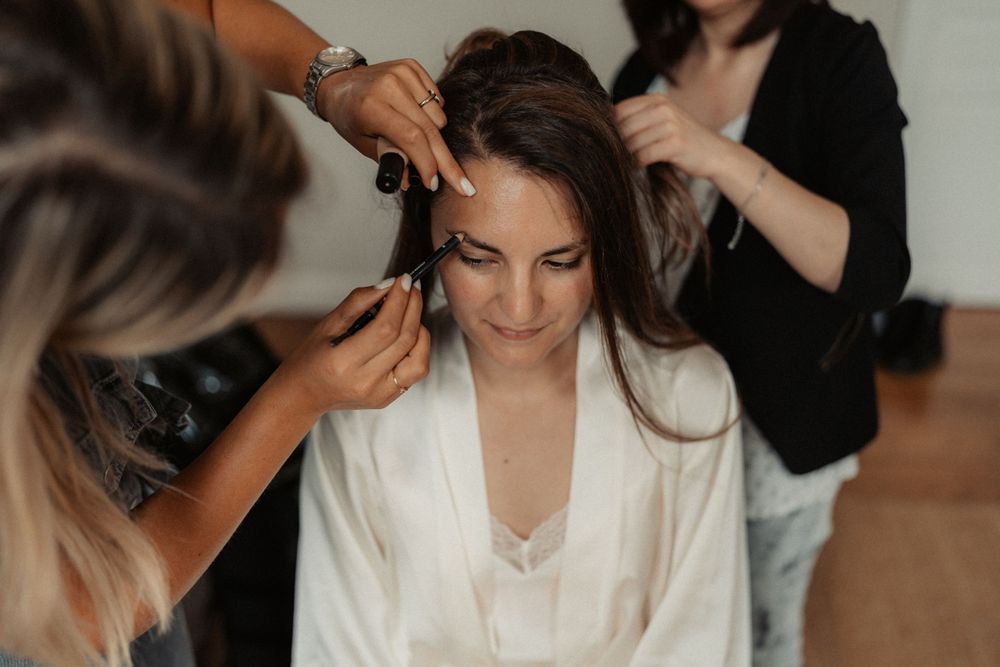 Getting ready scene with styling tools and white robes.