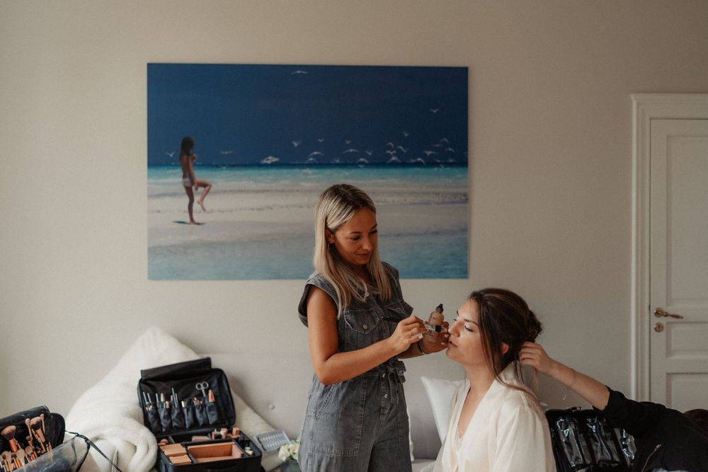 Beauty preparation scene with coastal artwork in the background.