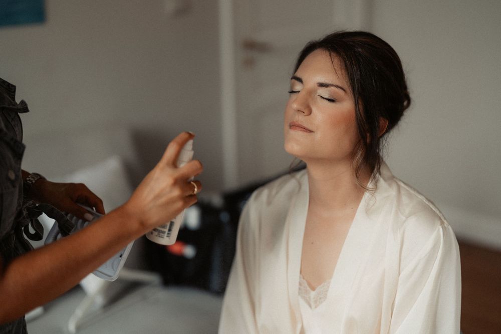 Getting ready scene with beauty products and white robe.