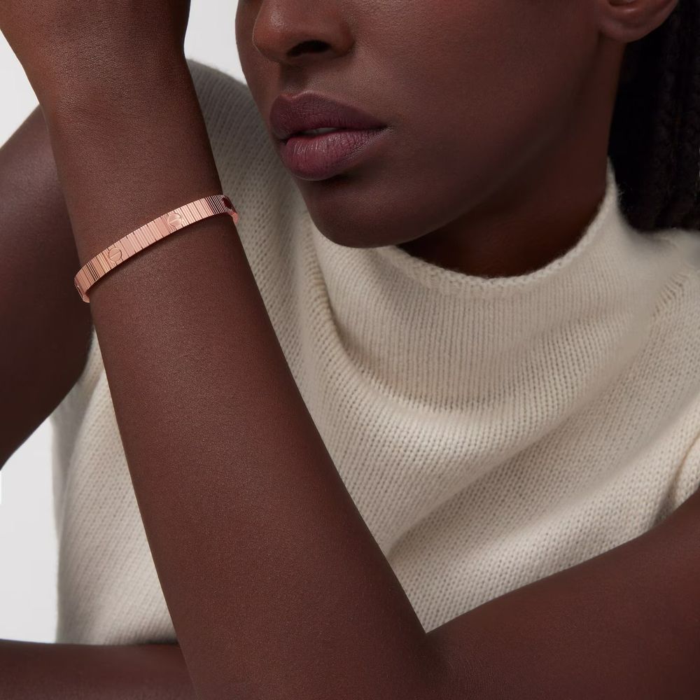 Close up beauty portrait of person in cream turtleneck sweater against neutral background.