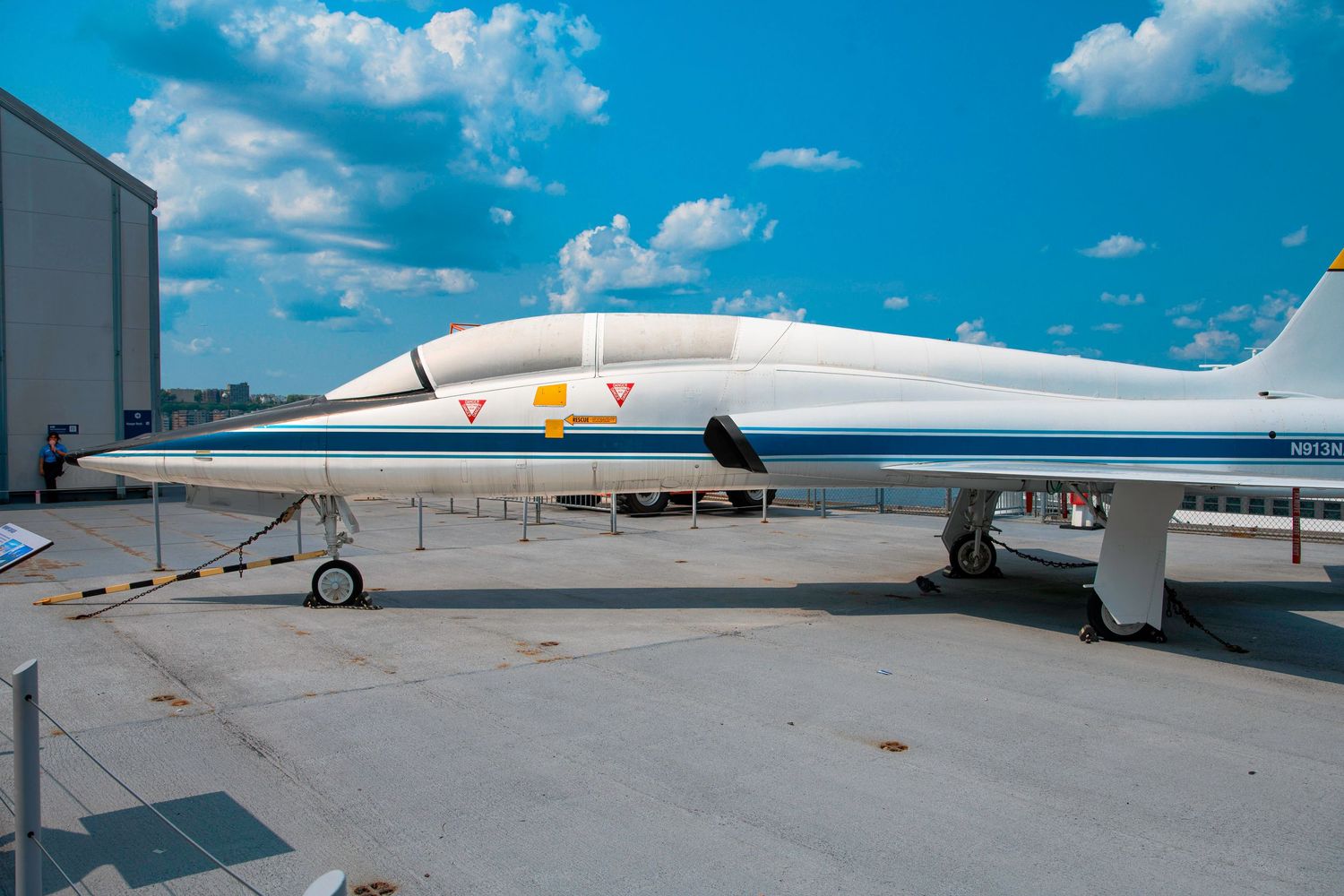A streamlined white supersonic aircraft displayed in an outdoor museum setting.