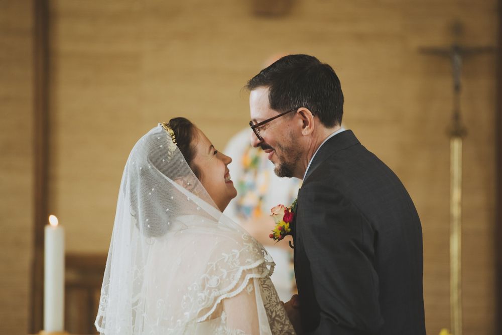 Intimate moment between newlyweds during their church wedding ceremony.