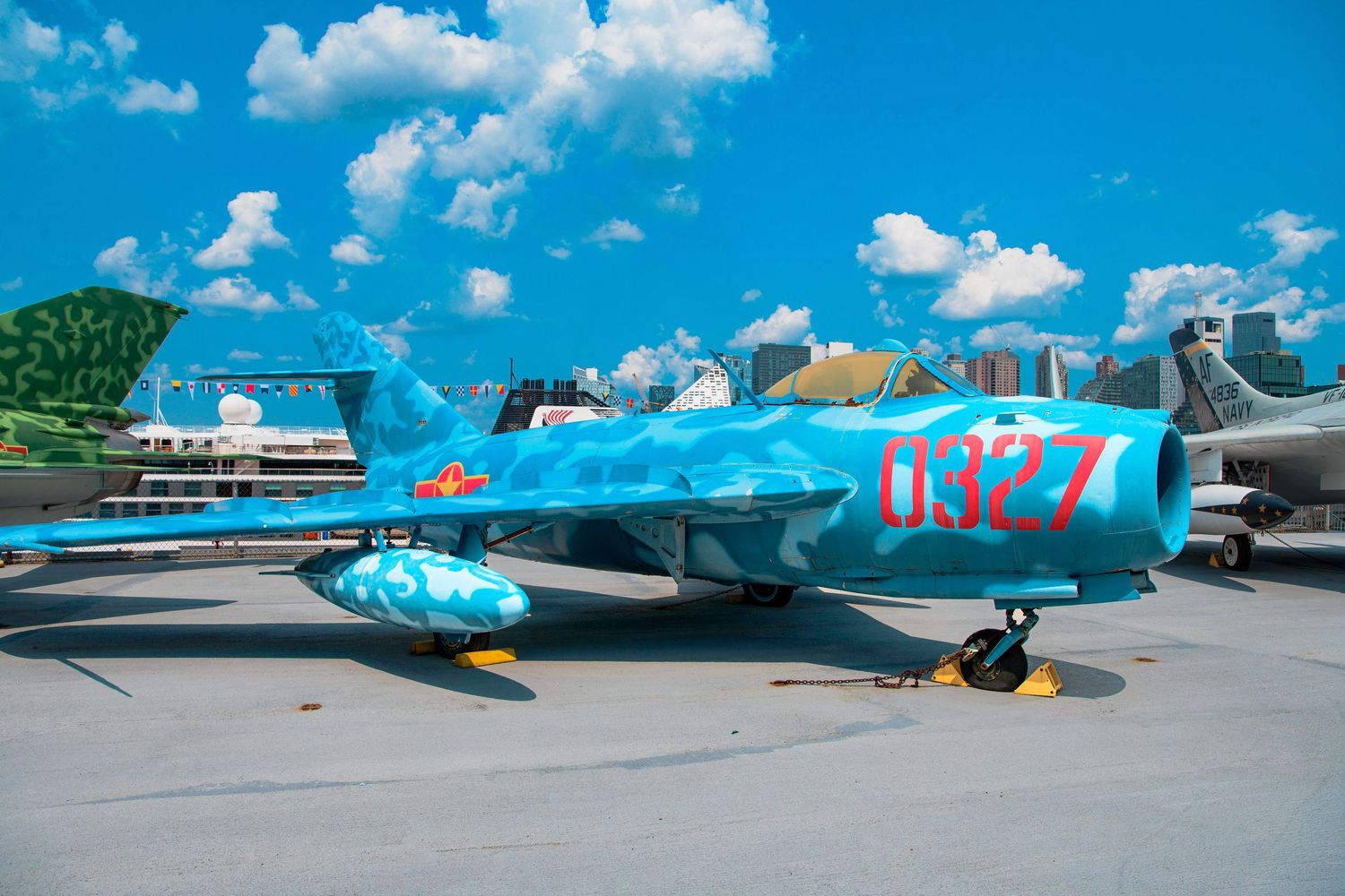 A vintage military jet aircraft in blue and gray paint scheme parked on display.