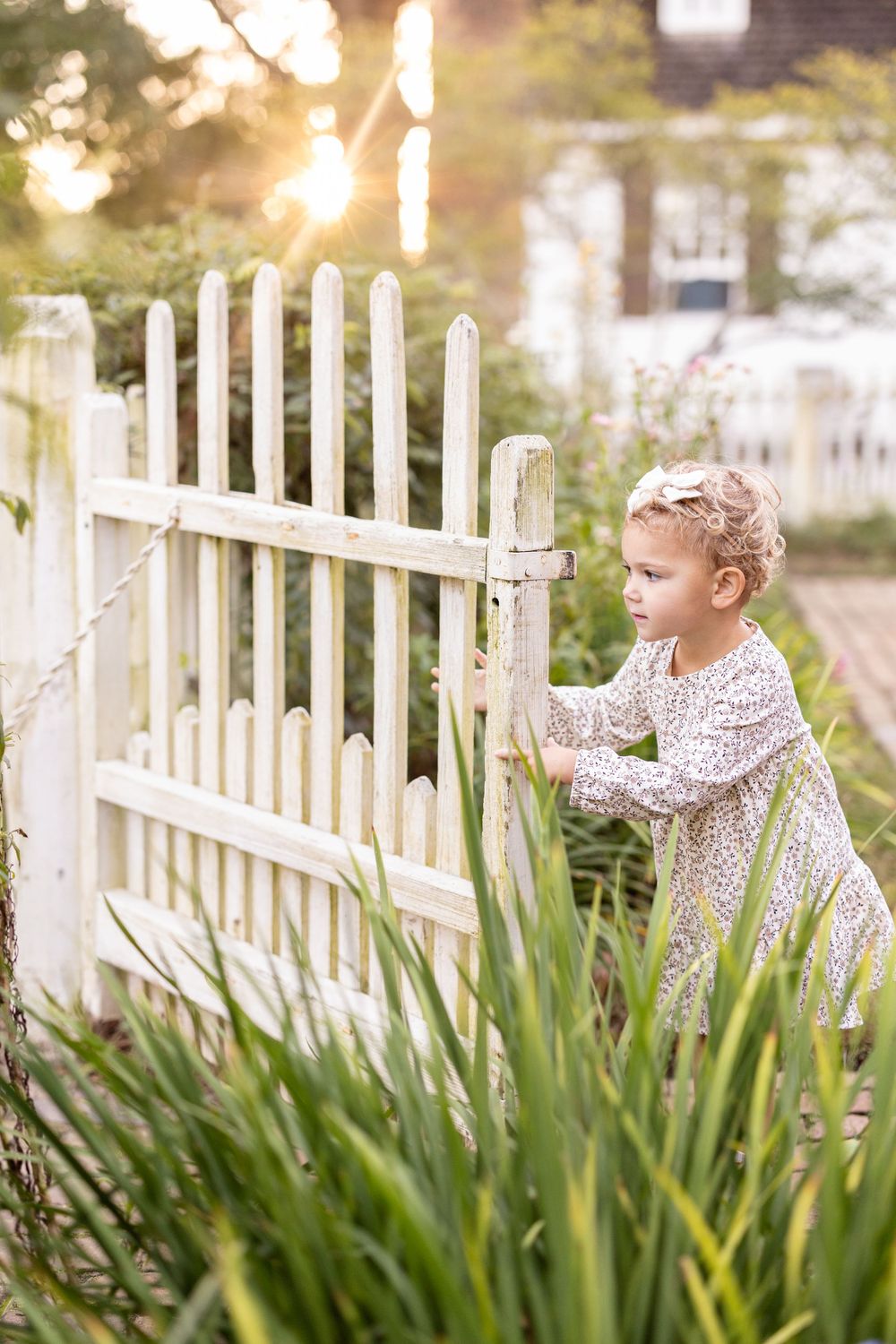 Photography of child opening gate in Colonial Williamsburg Virginia.