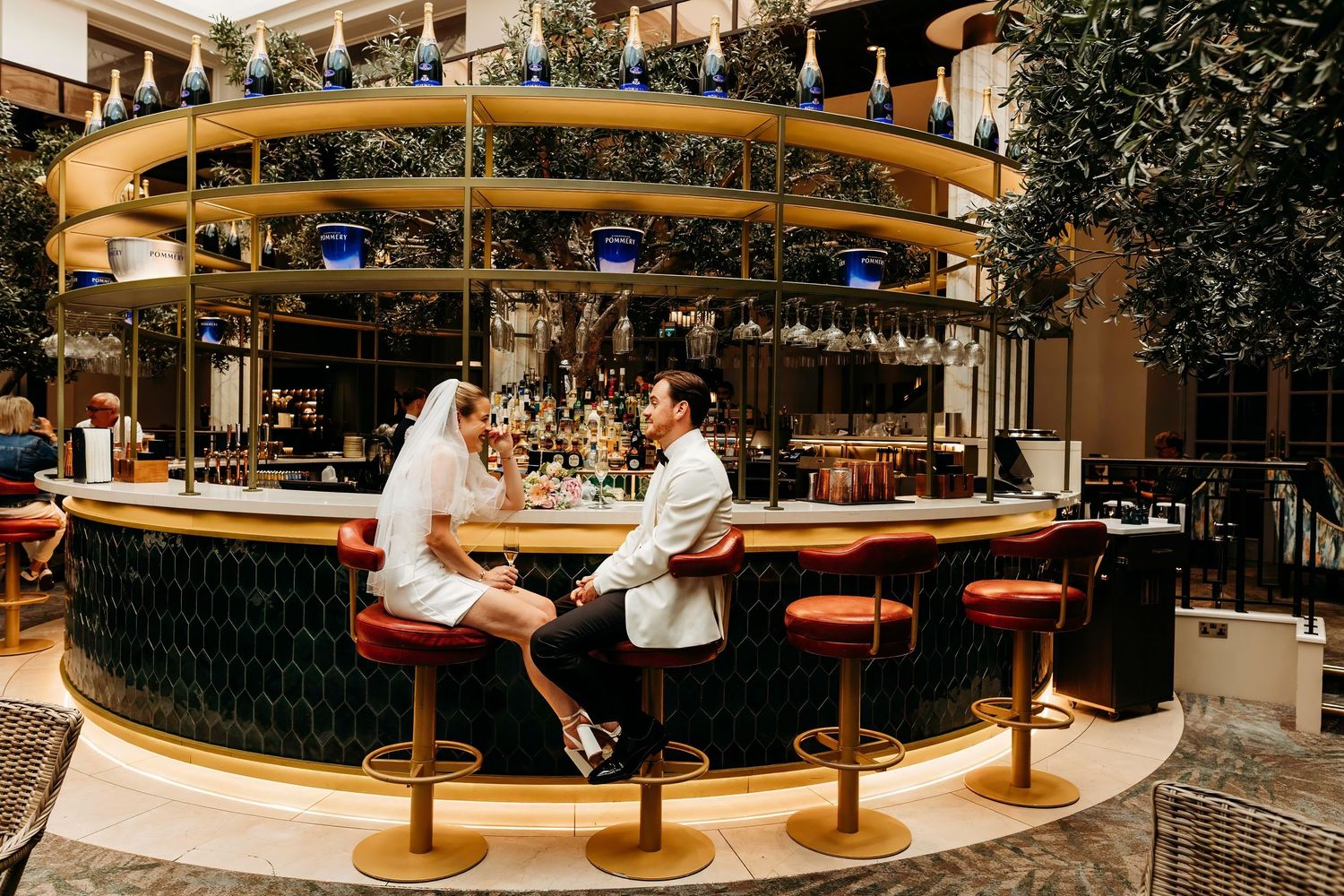 Interior view of a trendy restaurant with curved leather banquettes and warm lighting creating an elegant atmosphere.