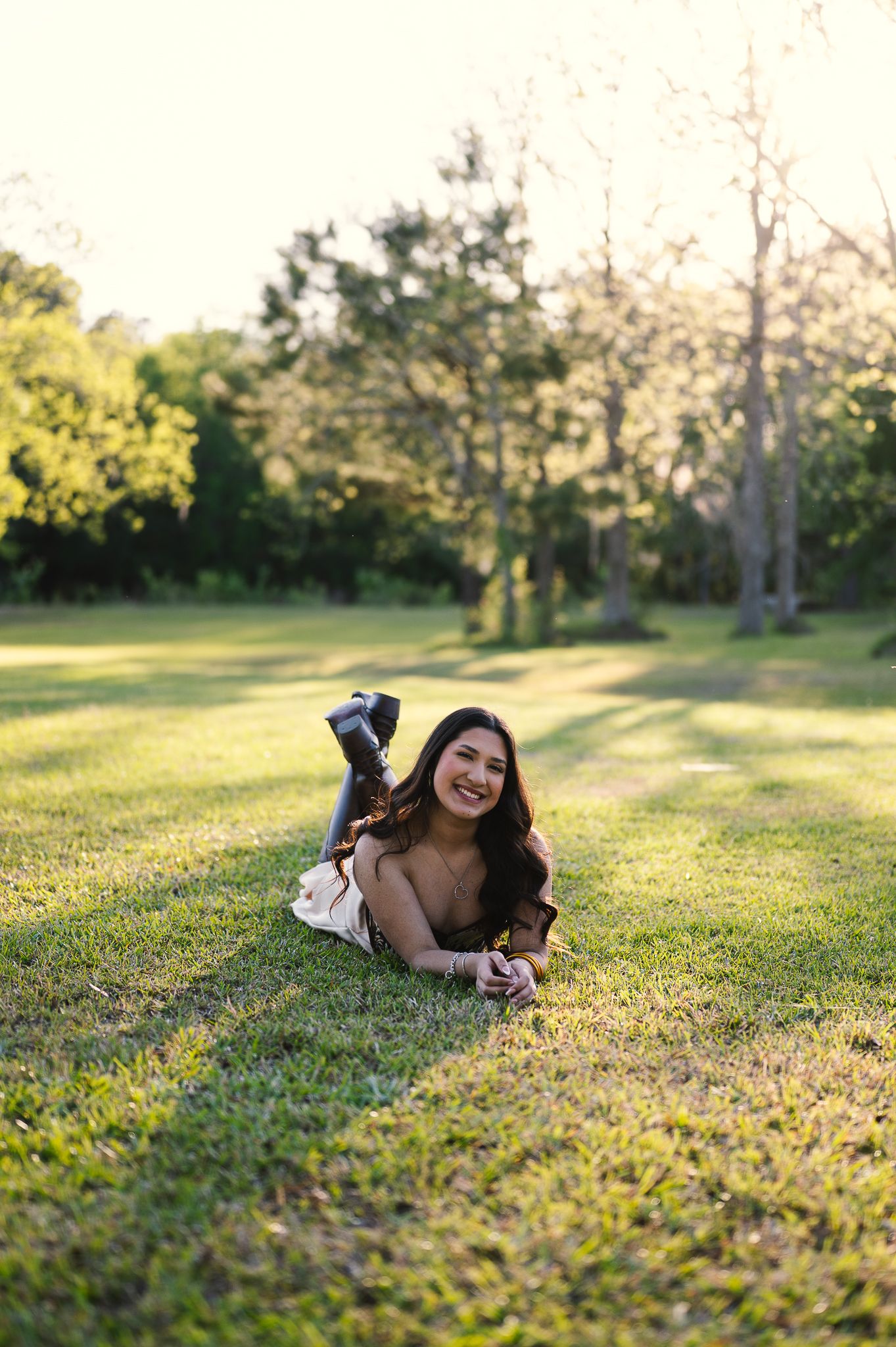 A sweet moment captured outdoors with a pink-shirted figure holding a small child against a wooded background.