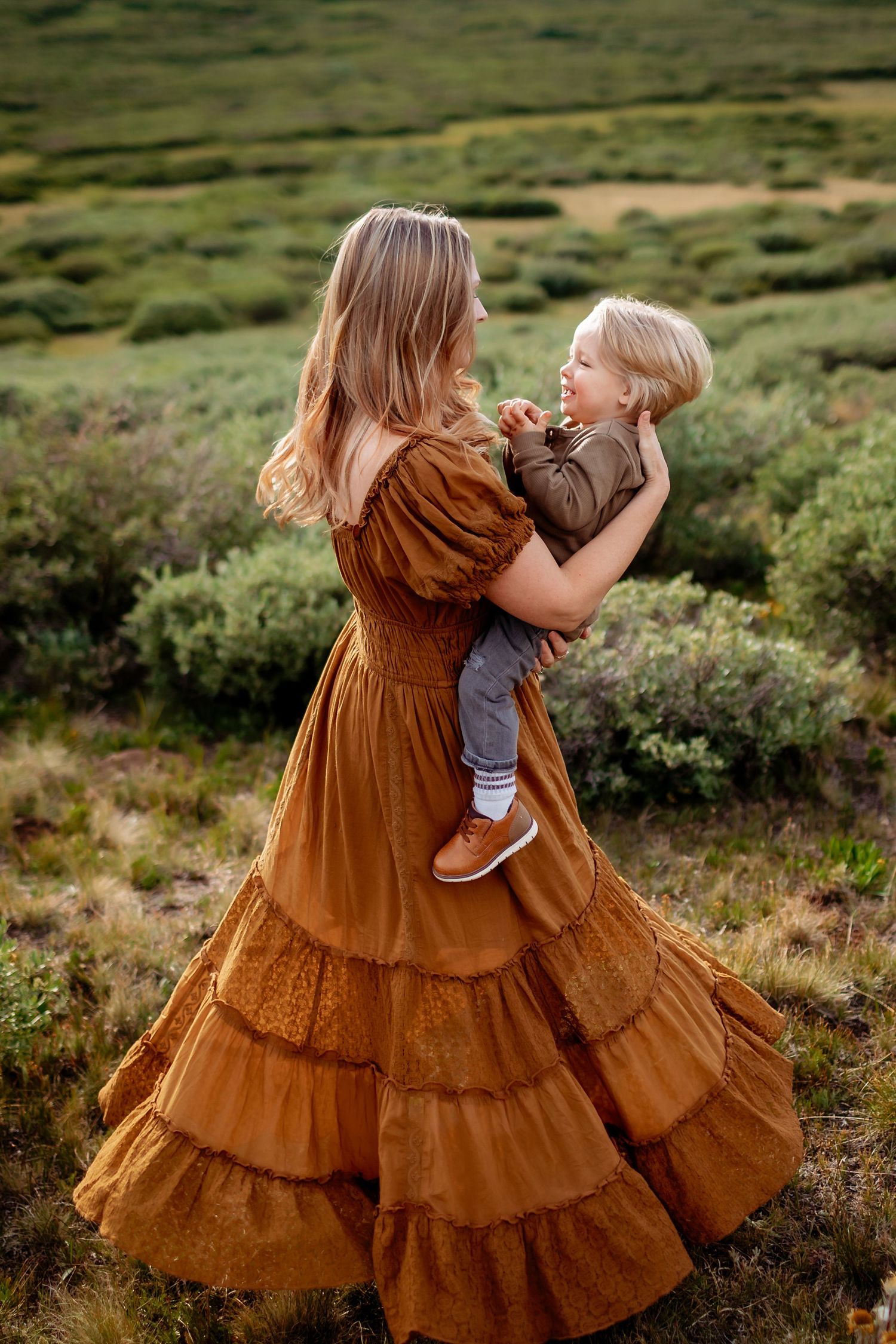 Parent and child embracing in matching brown dresses against a backdrop Navarre Florida