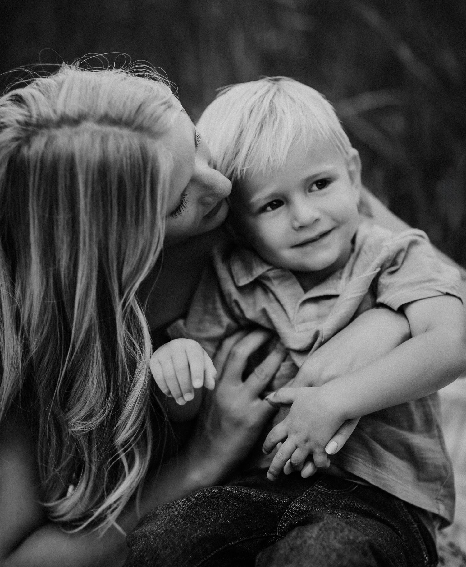Black and white images of tender family moments showing hugs and embraces between parent and child inNavarre Florida