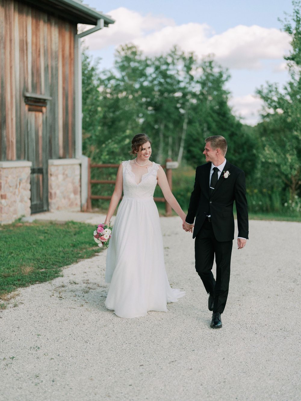 Classic and film-inspired wedding photography in Madison, Wisconsin. Bride and Groom walking candid portrait at The Wade House Glenbeulah.
