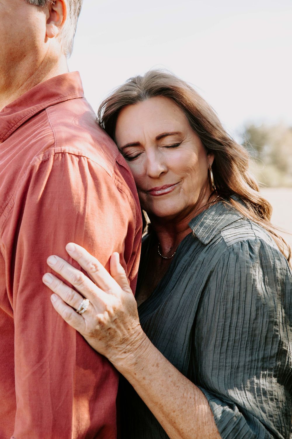 Close-up shots capture intimate moments between couple wearing coral and gray outfits.