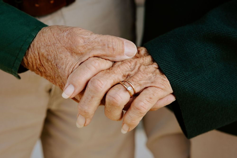 Close-up view of hands clasped together showing connection and intimacy.