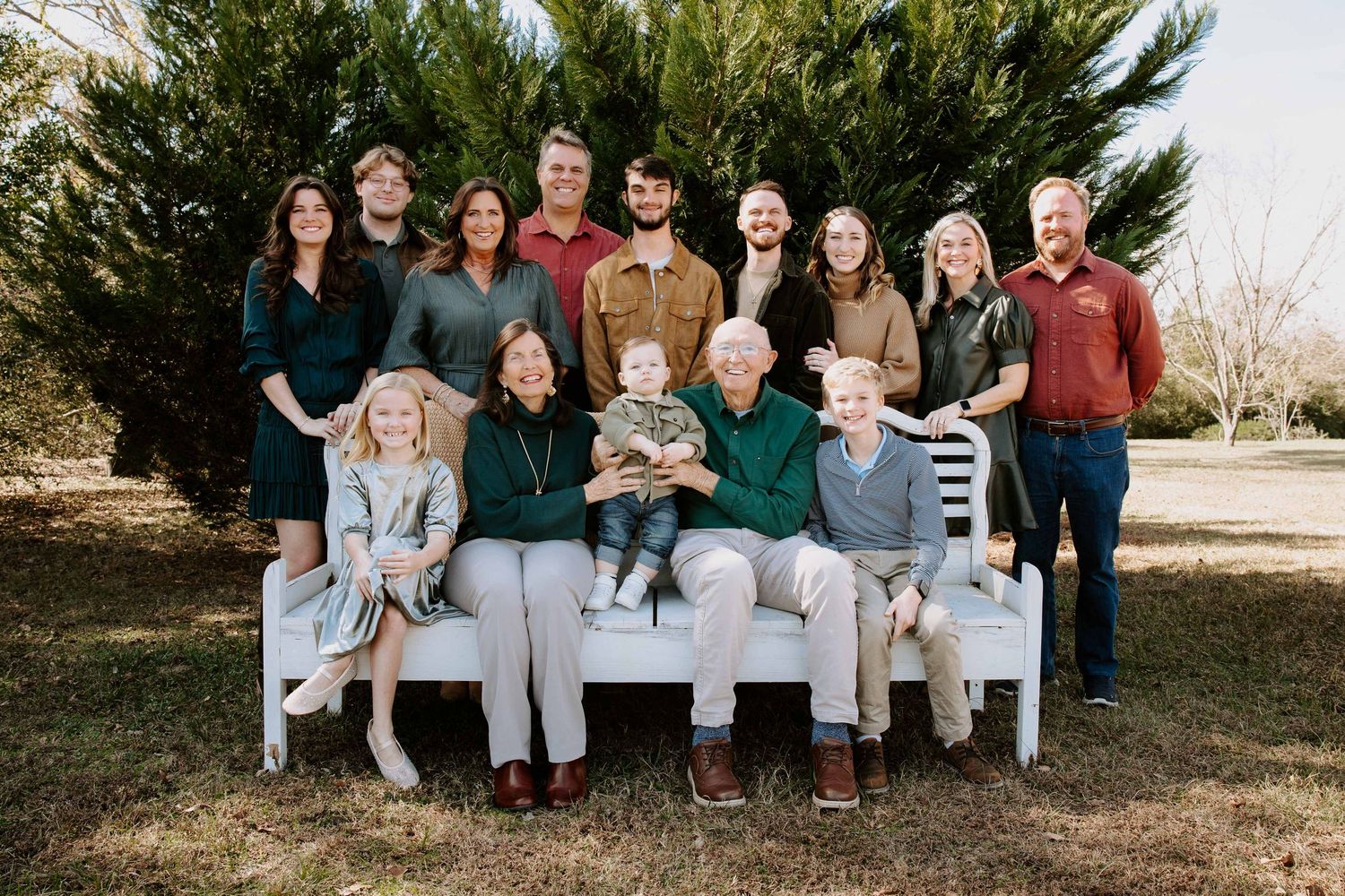 A collection of six outdoor family portrait photos showing groups sitting together in casual attire.