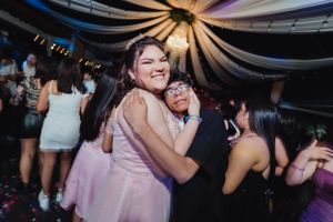 Celebratory dance moment captured between two partygoers at a festive indoor event.