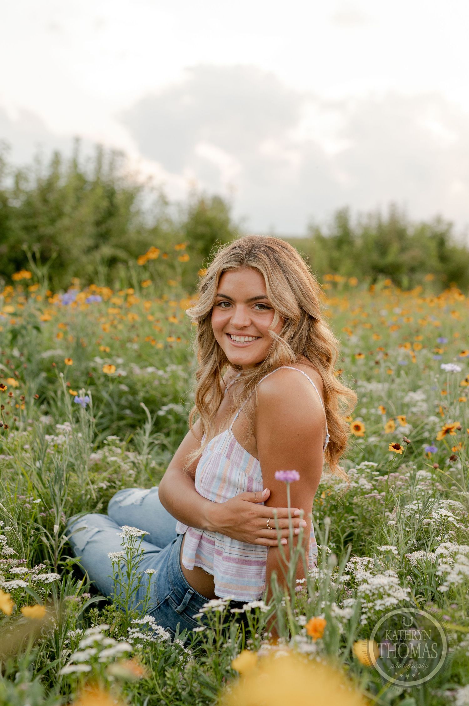 Casual outdoor portrait in a wildflower field with white wildflowers and natural lighting.