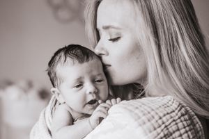 Intimate black and white portrait series showing tender family moments.