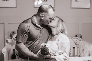 Black and white lifestyle photos capturing tender moments between family members.