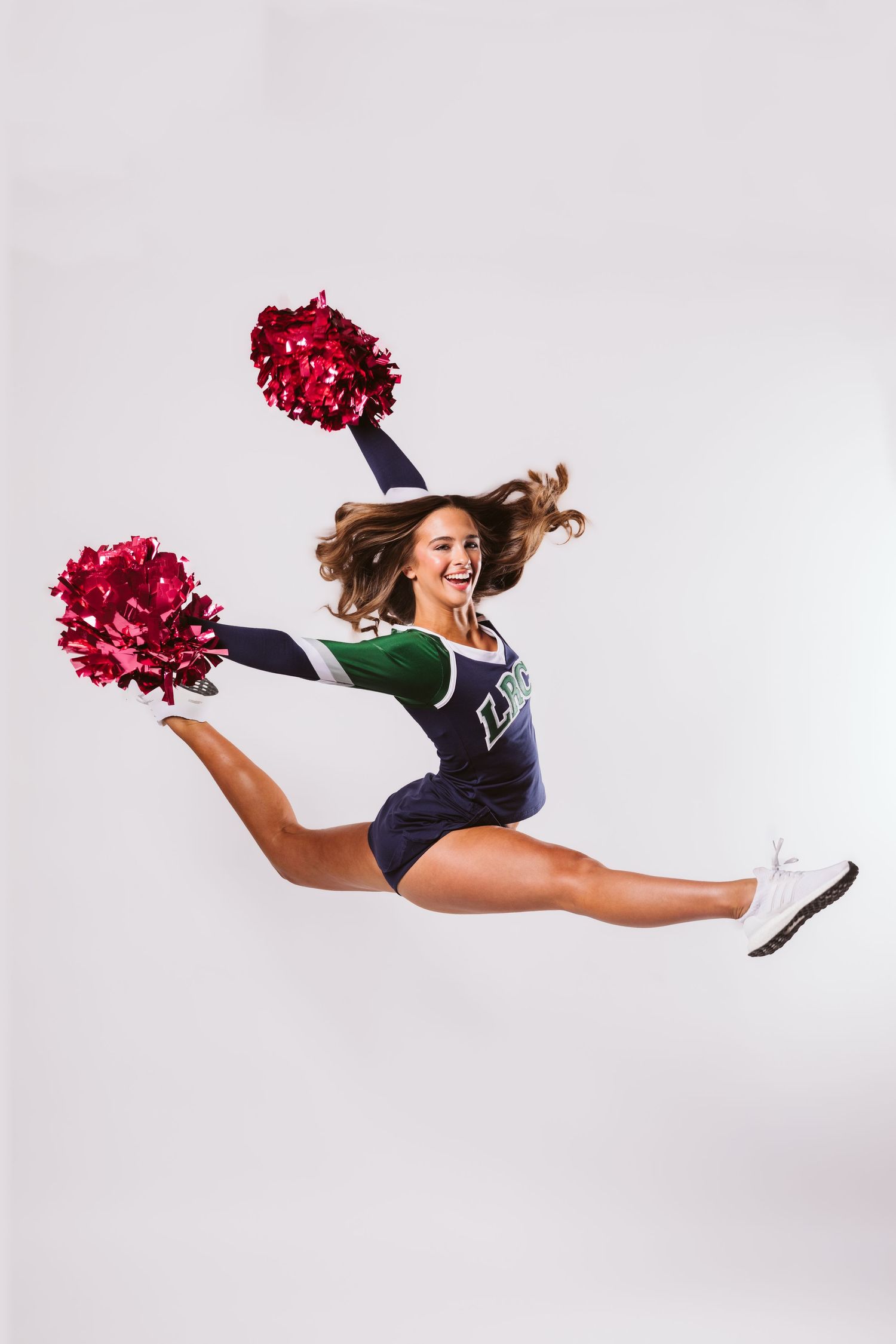 cheerleader jumping with poms