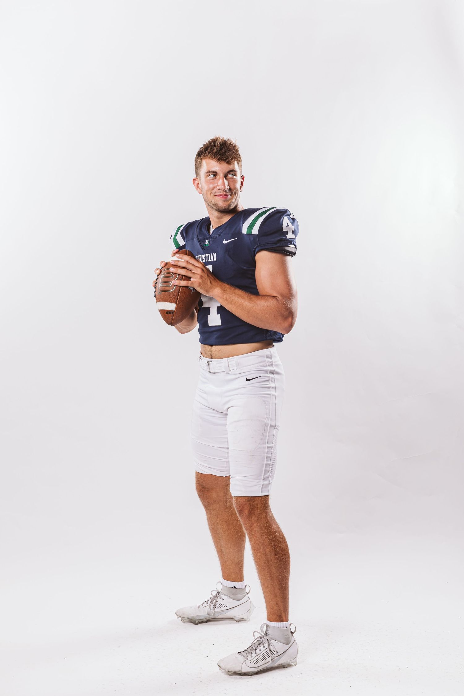 quarterback holding and about to throw football walker white