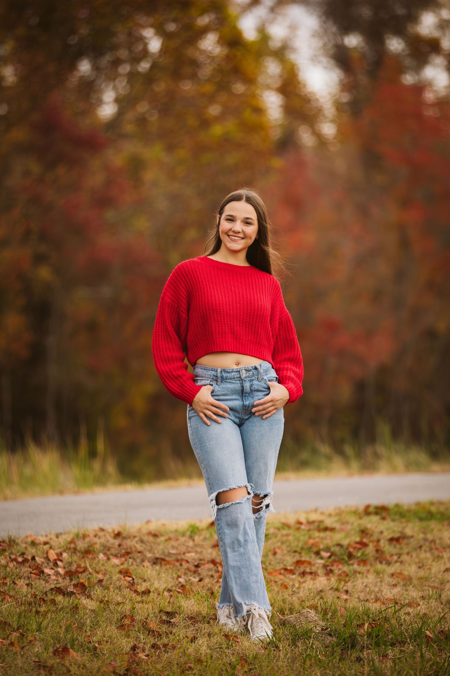 Senior session of girl in red sweater and jeans in fall season