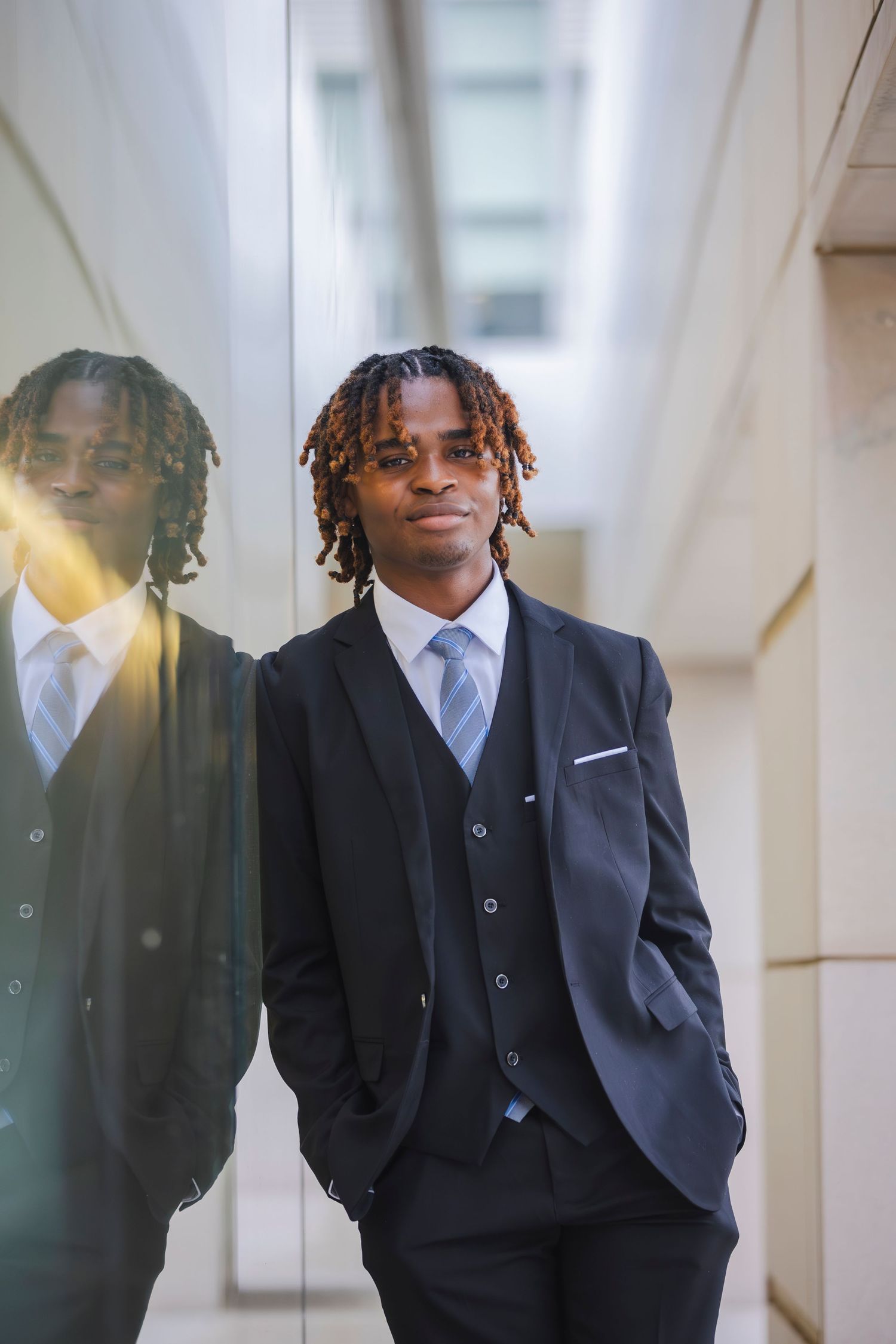 Student well dressed leaning on wall for senior session